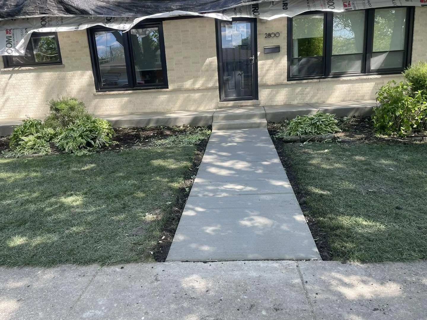 New front walkway leading to a home entrance