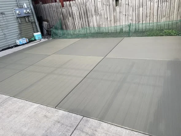 Finished backyard concrete slab with clean control joints