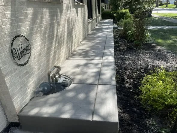 Finished concrete sidewalk along a building