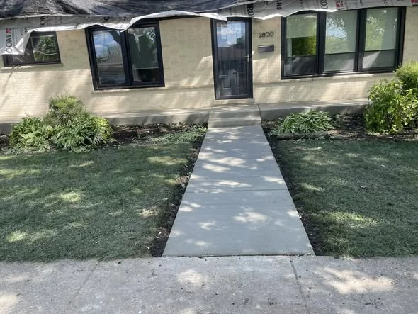 New concrete walkway leading to front entry