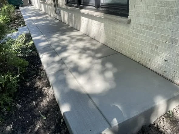 Clean concrete walkway beside a building